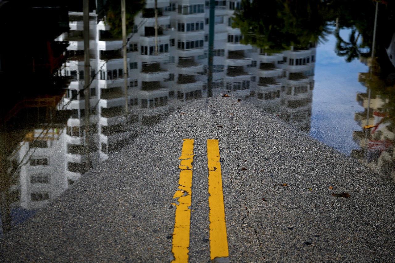 A street flooded with high water caused by an annual so-called king tide in Fort Lauderdale, Fla., Nov. 14, 2016. The frequent king tides are the most blatant example of the interplay between sea level rise and the alignment of the moon, sun and Earth. Even without a drop of rain, many places in South Florida flood like clockwork. (Scott McIntyre/The New York Times)